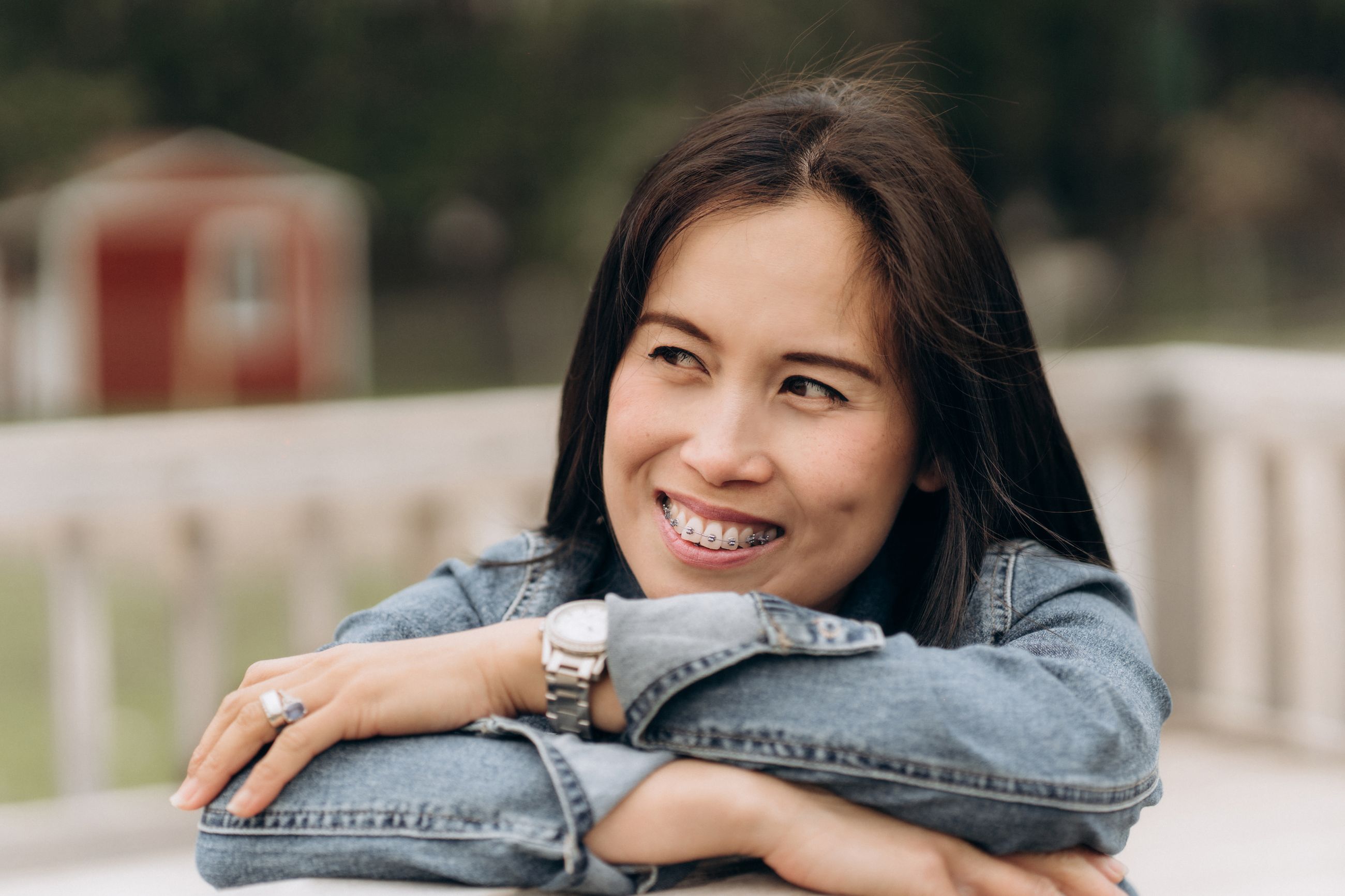 An adult woman smiling with braces