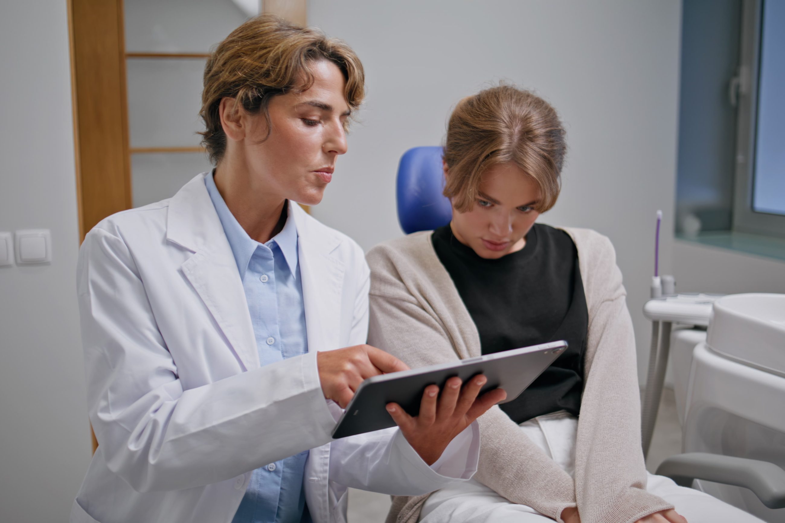 A team member walking a patient through her plan on a tablet
