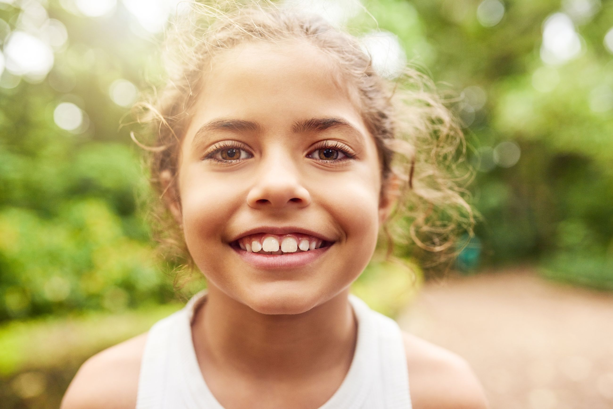 A smiling young girl outdoors