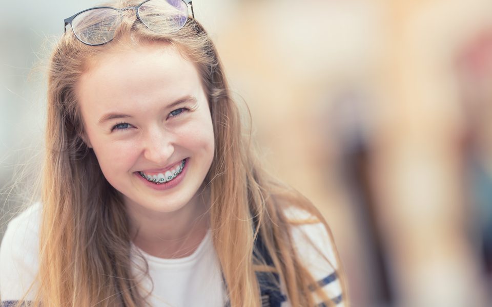 A smiling teenage girl with braces