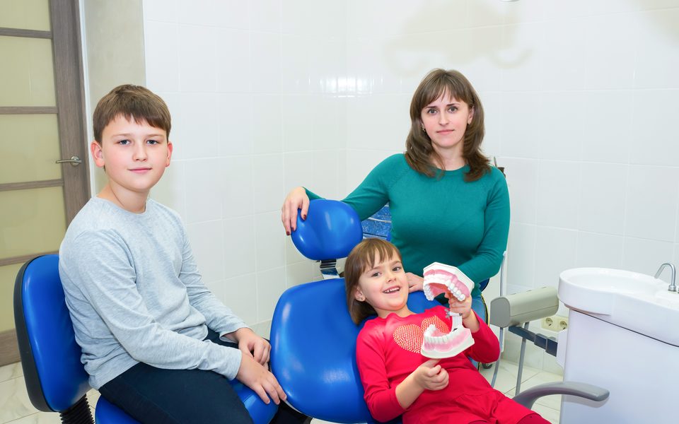 A mother and her children at an orthodontic visit