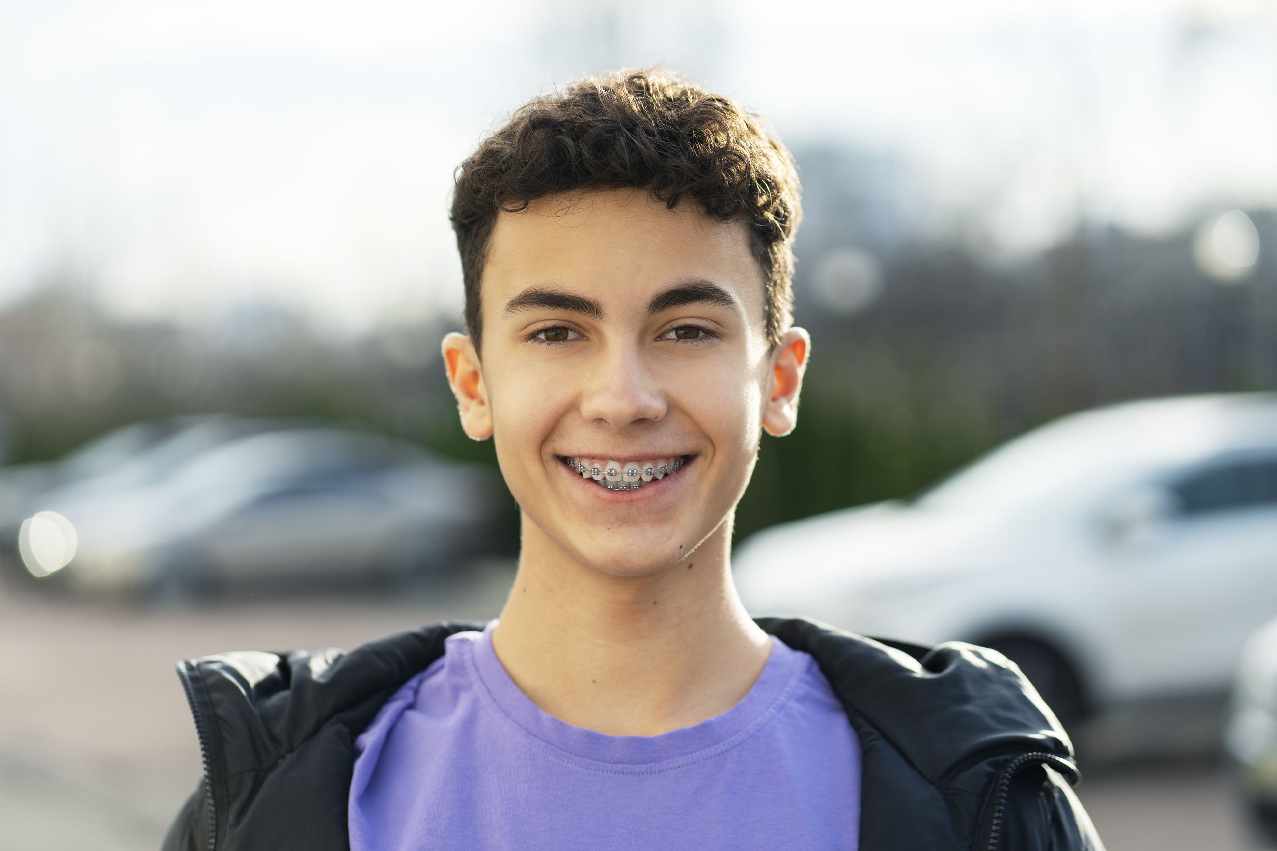 A teenage boy smiling with metal braces