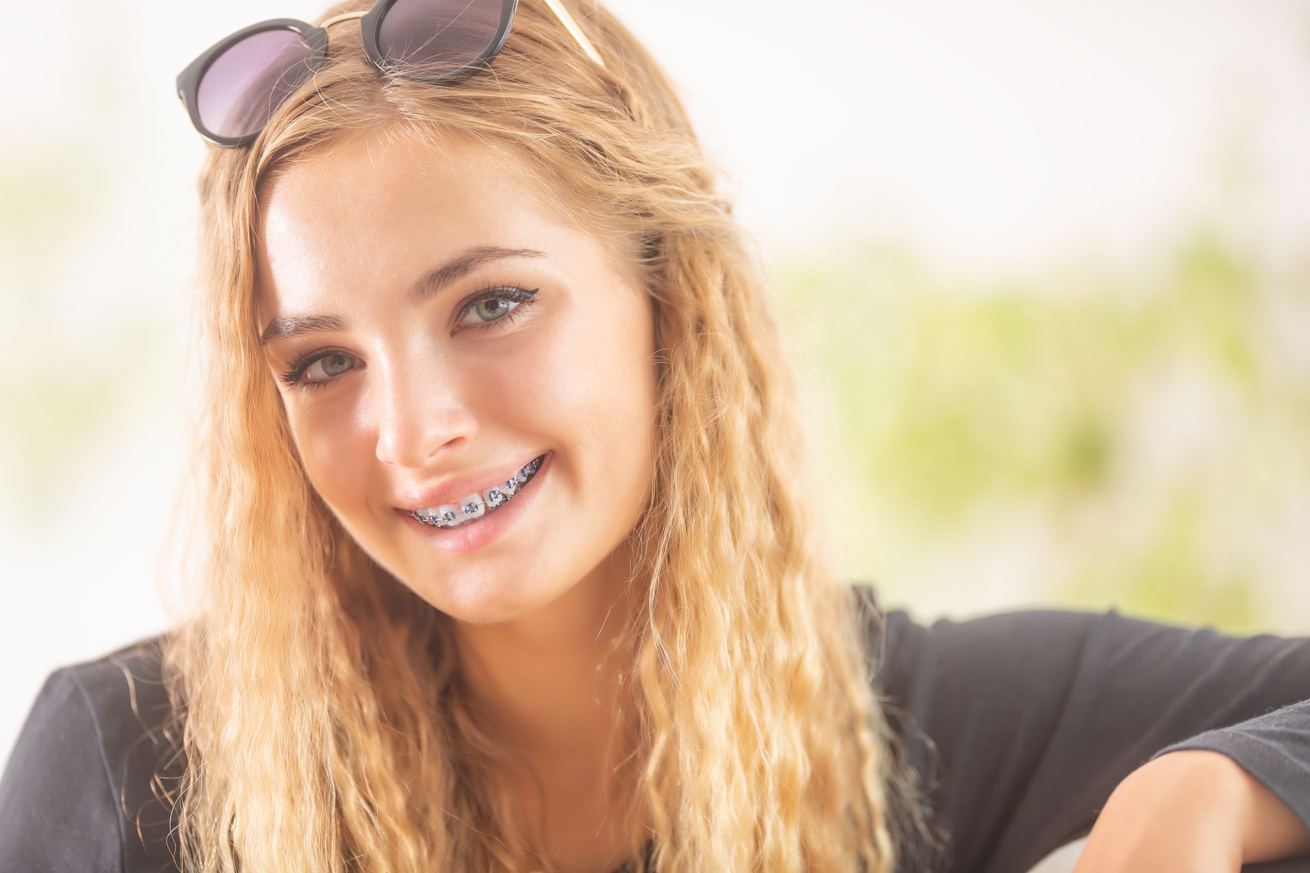 A teenage girl smiling with her new braces